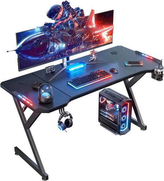 55 Inch Gaming Desk with LED Lights Ergonomic Computer Gaming Table with Carbon Fiber Surface Sturdy PC Workstation Desk for Gaming and Home Office with Headphone Hook Cup Holder Black